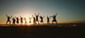 people jumping on the beach in sunset in one of the fastest growing cities in Florida