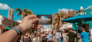 looking at a ticket of Universal studios while following the moving trends in Florida