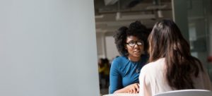 a girl on a job interview asking the most common questions about moving to Miami