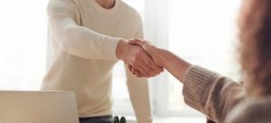 person shaking hands in office