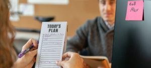 person holding checklist while looking for the best places to find work in Florida