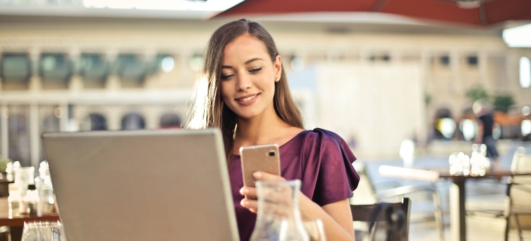 girl smiling and looking at her phone