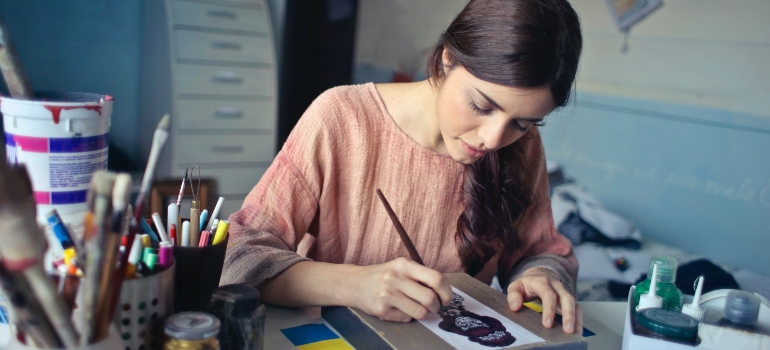 woman painting and thinking about the best places in Florida to start a small business
