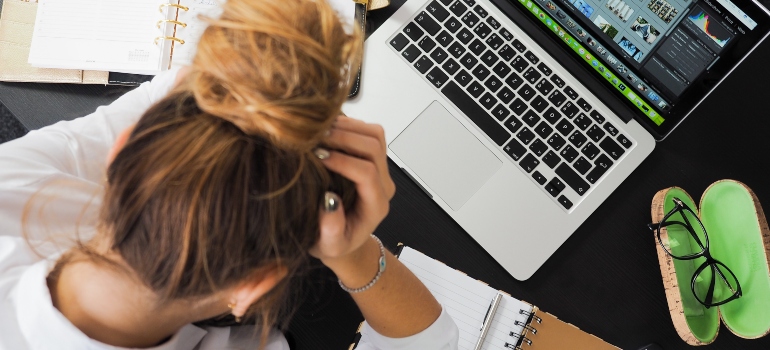 woman thinking over laptop