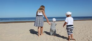 three kids walking on the beach