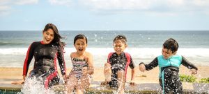 a family playing on the beach