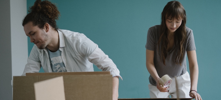 two persons packing in the boxes
