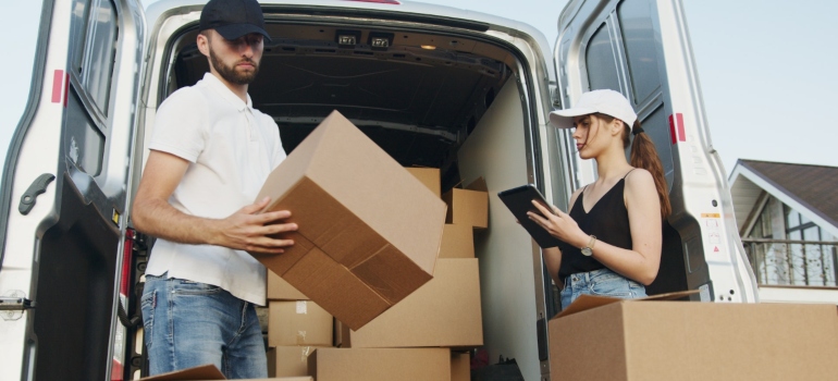 a man and a woman packing into a van