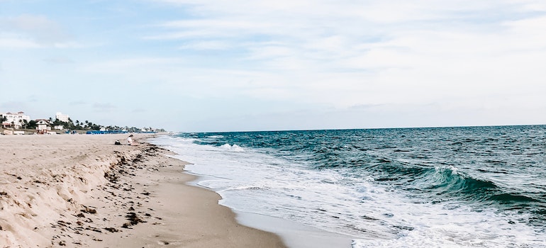 Calm Body of Water Beside Sand