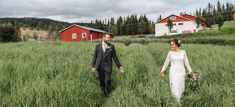 newlyweds walking in the grass in one of the top places for newlyweds in Florida