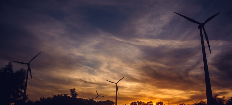 wind turbines with a colorful sunset in the background