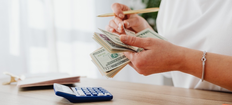 person calculating the costs of moving to Fort Lauderdale