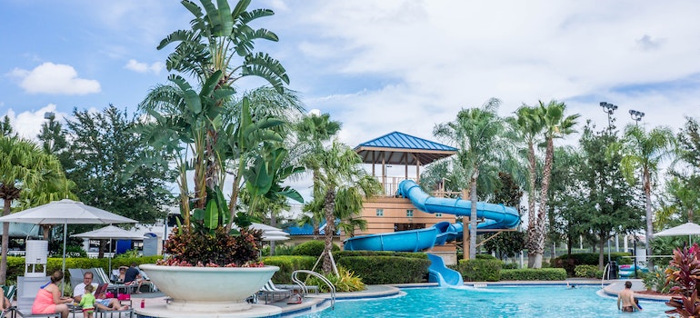 An aquatic adventure park in florida with a twisted loop and palm trees