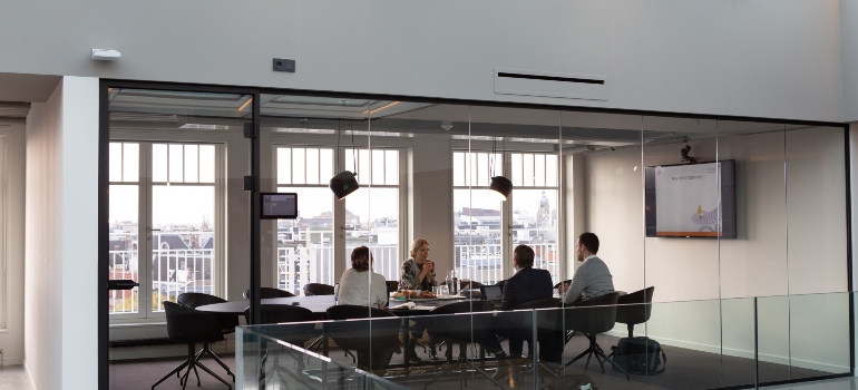 persons at desk planning a large-scale office move