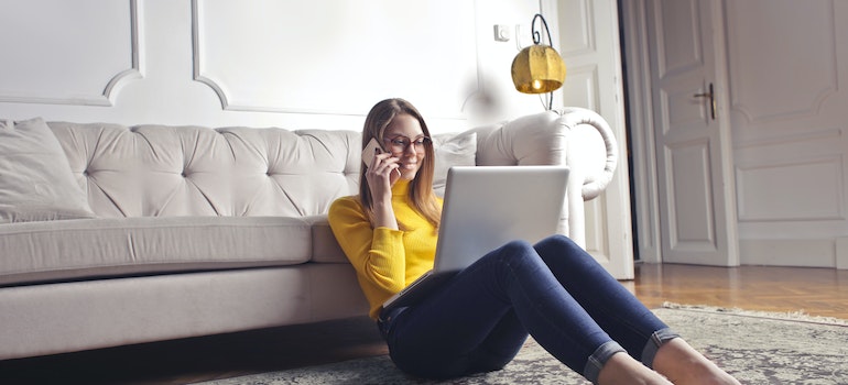 Woman talking on the phone and using laptop