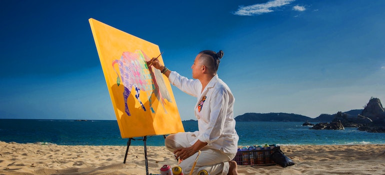 Artist on a beach in one of the top FL cities for culture and art lovers