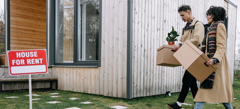 man and woman moving into a rental house