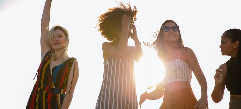 Young girls dancing at music festival which is one of the creative ways to make friends in Miami