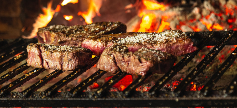 steaks grilled on charcoal fire
