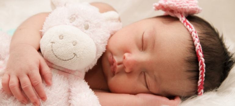 A newborn baby sleeping on the pillow