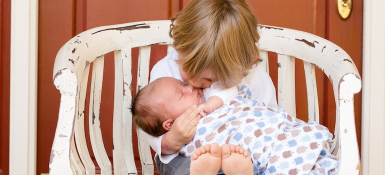 Boy carrying his baby brother