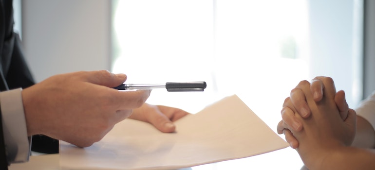 Businessman giving a contract to a woman