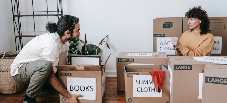A couple packing and talking about how to set up your moving binder