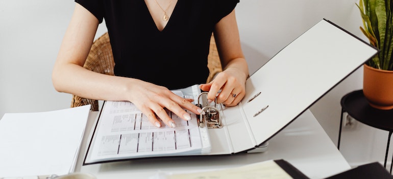 Woman setting up a moving binder