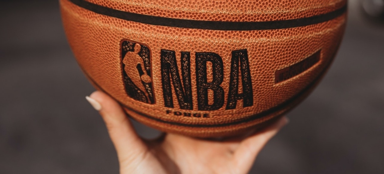 a person holding a basket ball as one of the ways to have fun after moving to Miami