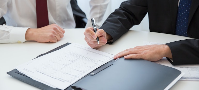 signing a contract after trying to find affordable housing in Florida for retirement