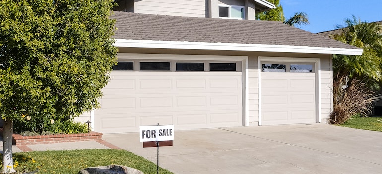 looking at a home for sale sign while trying to find affordable housing in Florida for retirement