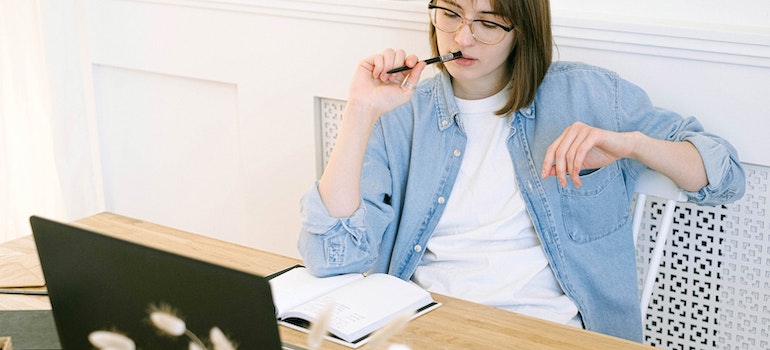 woman thinking about the pros and cons of DIY moving in Miami