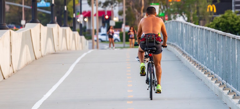 man on a bicycle thinking about Aventura or Plantation