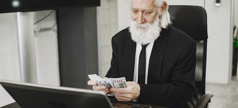 elderly man counting money