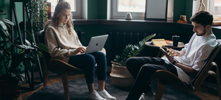 couple using laptops