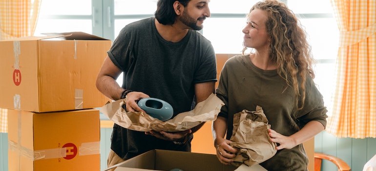 couple using alternative packing materials when moving