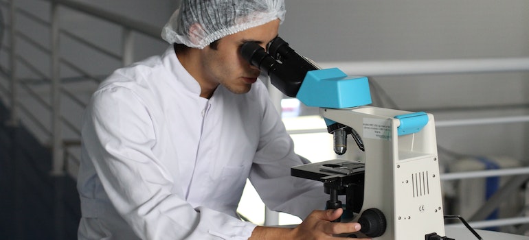 looking through microscope
