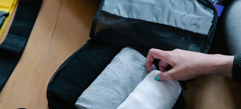 packing clothes after reading our checklist for moving to Florida by car