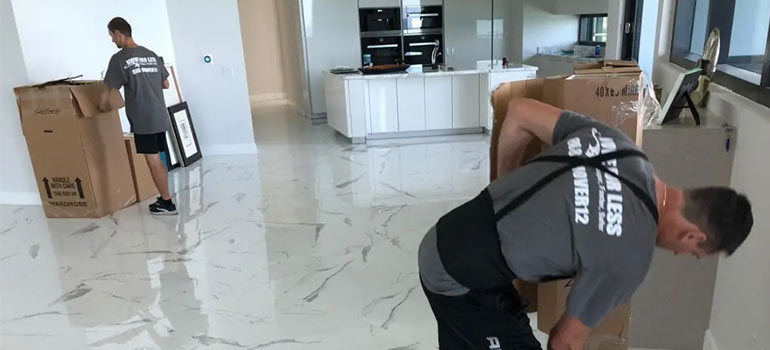 Miami movers loading moving boxes with clothes