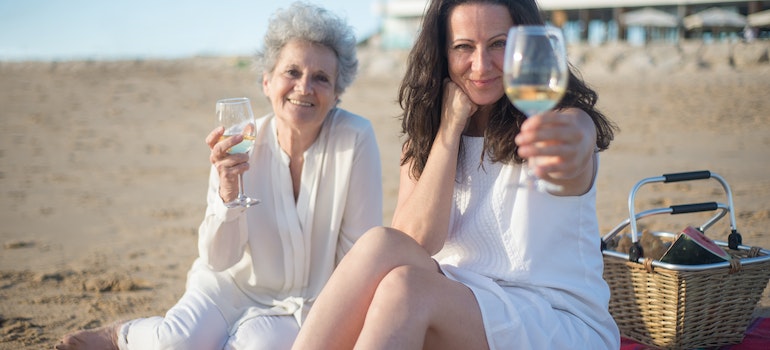 two women on a beach talking about why so many New Yorkers move to Florida