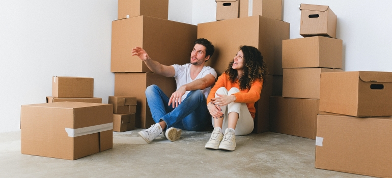 couple among boxes talking about how to pack a house in under a week