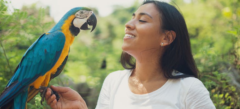 woman holding a parrot