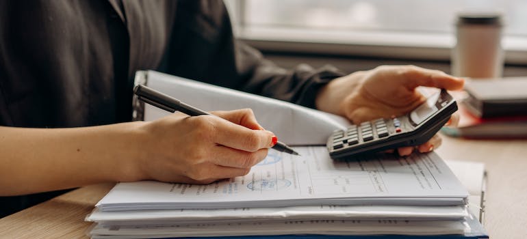 using calculator while thinking about the things to consider when moving your office