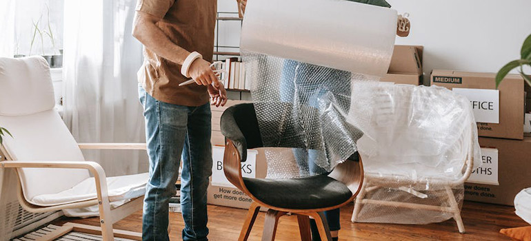 wrapping furniture before packing a moving truck