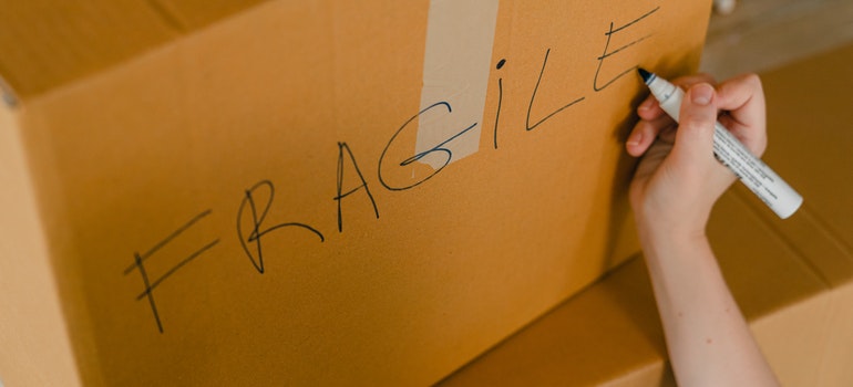 labeling boxes prior to Miami movers and packers arrival