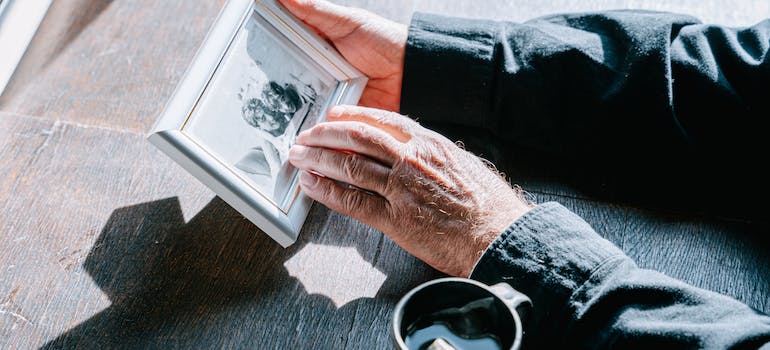 holding an old photo