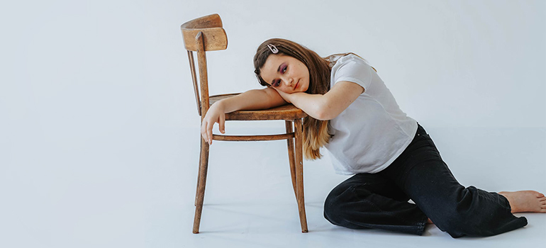 woman hugging an old chair