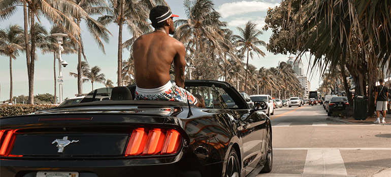a man riding on a car
