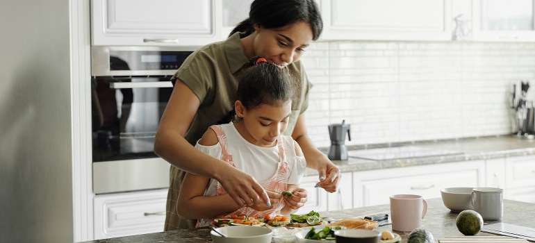 mom and kids preparing things that they will be eating during a move