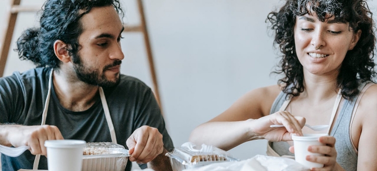 young couple eating during a move